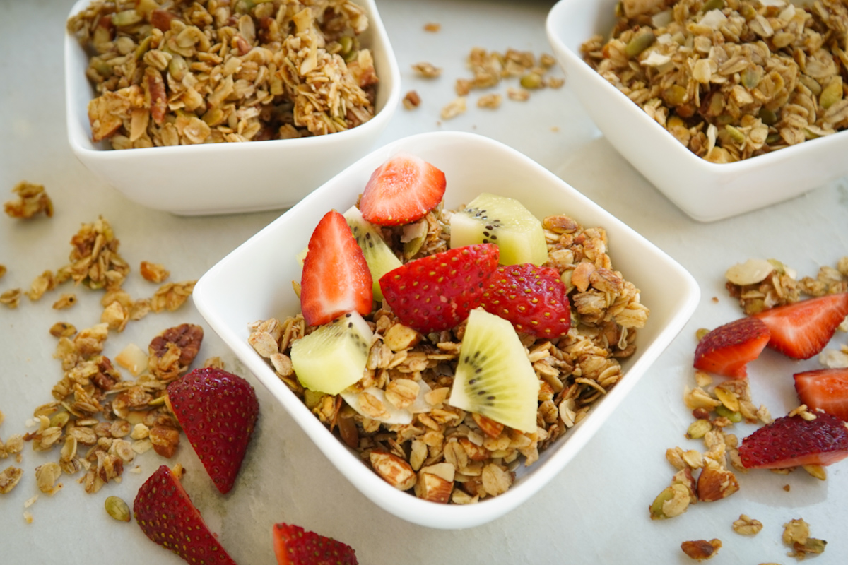 granola with bright fresh fruit topping - sliced strawberries and kiwis